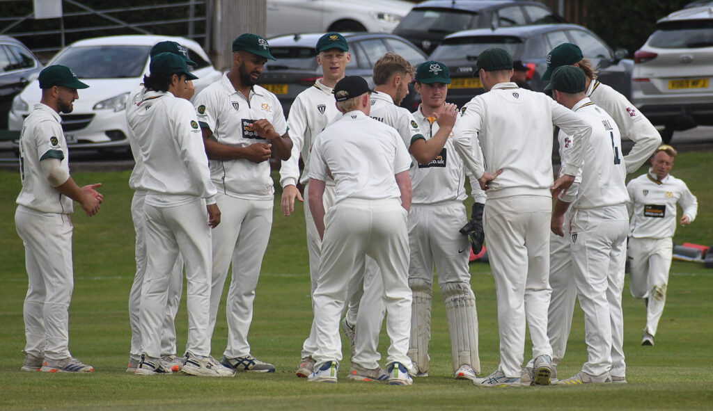 Staffordshire celebrate taking a Lincolnshire wicket on the second day at Checkley.